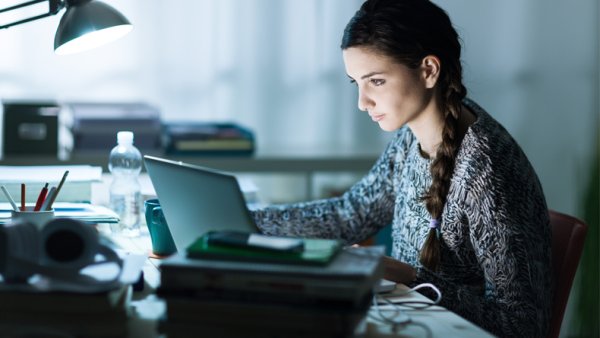 A girl studying on a laptop
